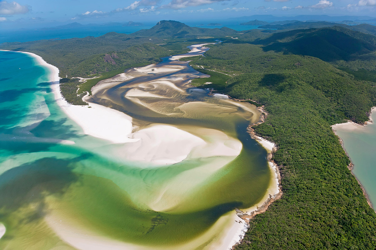 2023 yachting hotspots – the swirling sands of Whitsunday Islands, Australia, that separate the clear waters and dense forest